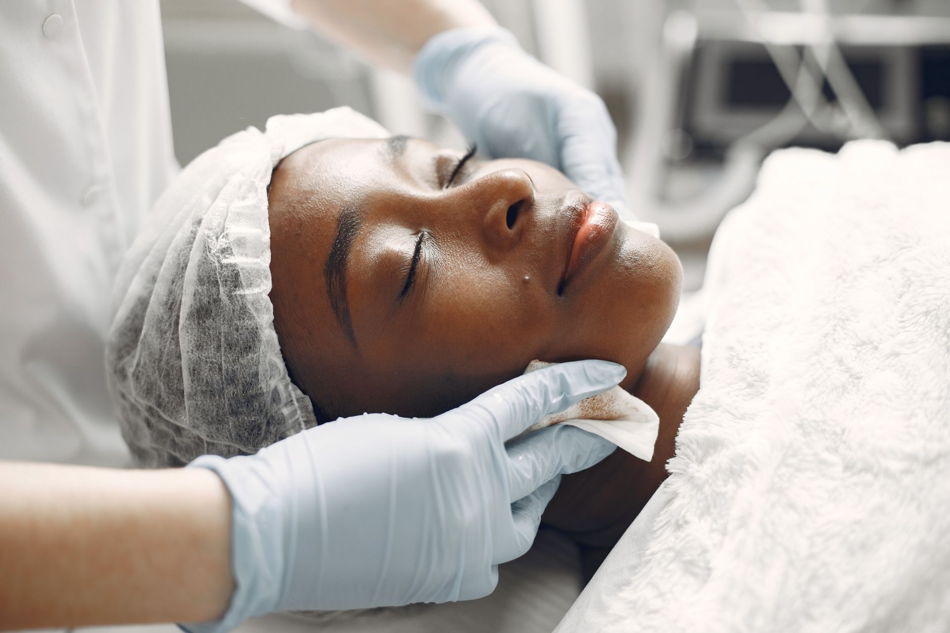 Facial skincare treatments — A woman enjoying a calming facial treatment at a spa, promoting relaxation and rejuvenation.