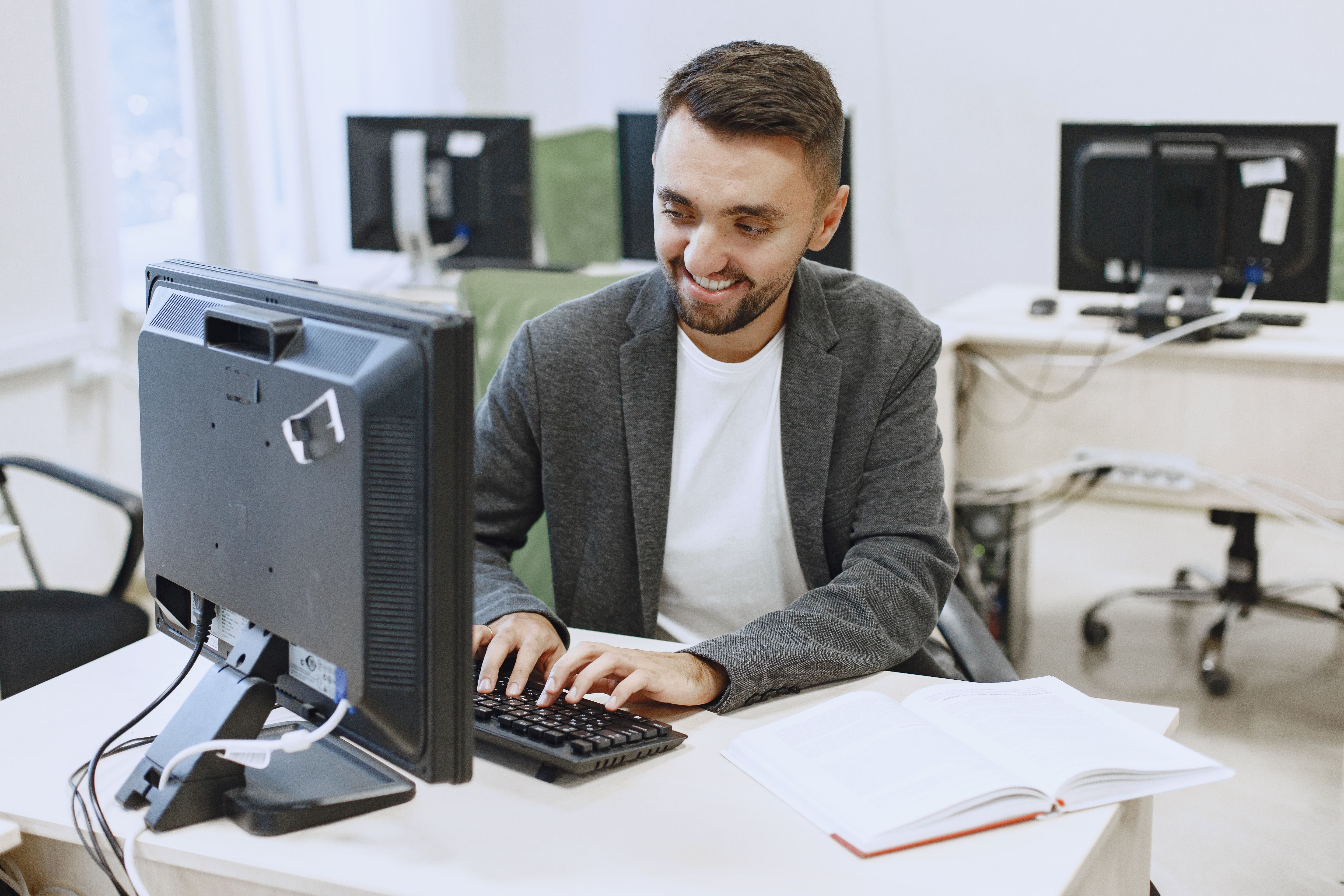 Pathway Level 5 Diploma in Information Technology — Asian students in uniform learning in a computer lab, focused on their tasks.